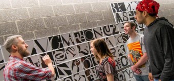 A creative rendering of the Periodic Table of Elements, the brainchild of David Mazure, East Stroudsburg University assistant professor of art, was carried out by students in two of his communication graphics classes. From left to right: Mazure; Rachel Holly, a freshman majoring in art and design from Lehighton, Pa.; Henry Becker, a junior majoring in art and design from Stroudsburg, Pa.; and Jeremy Soto, a sophomore majoring in art and design from Stroudsburg, Pa.