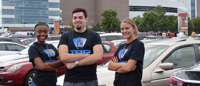 Three ESU students standing in front of the Wells Fargo Center