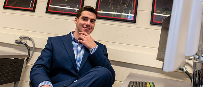 Michael Tomei sitting by a PC and smiling