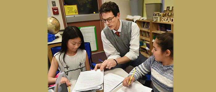 Trumbaurersville Elementary School Principal Adam Schmucker interacts with fifth-grade students in their classroom.