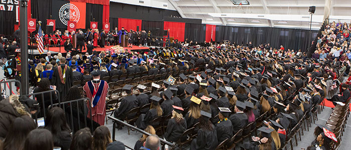 The fieldhouse at commencement filled with graduating students, faculty and administrators.