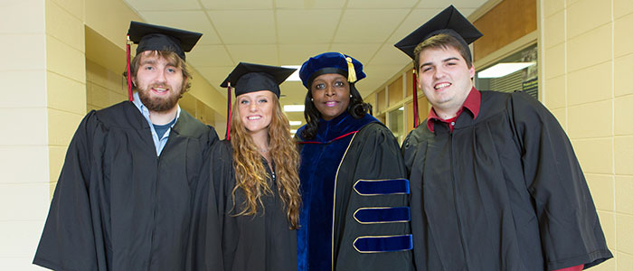 Joshua Pope, Madison Pope, Dr. Kimberly Adams, and Michael Pope prepare for graduation from East Stroudsburg University.