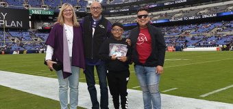 Dr. Solis being presented with award at Baltimore Ravens Stadium
