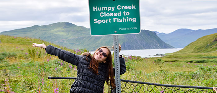 Leah Bergman posing in the outdoors by a sign